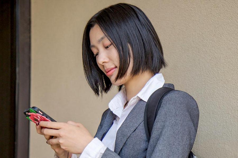 A student looks at her cellphone.