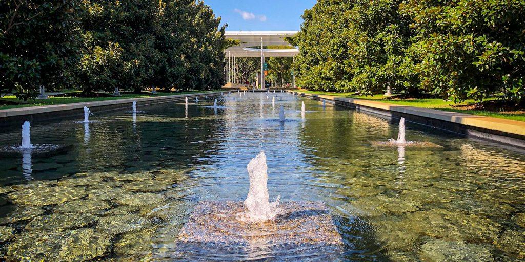 View of a reflecting pool on campus on a sunny day.