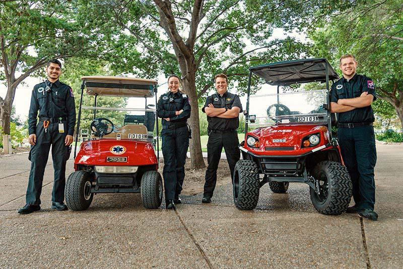 UEMR members standing next to carts.